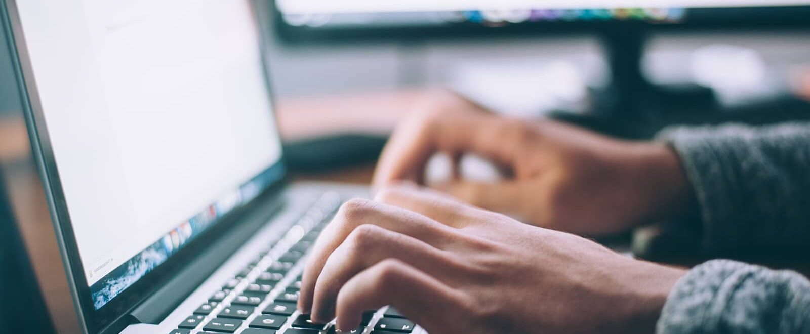 photo of person typing on laptop