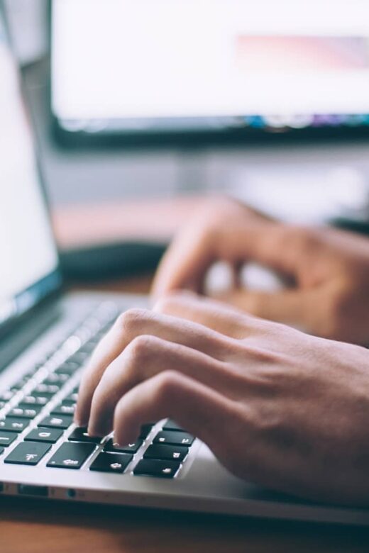 photo of person typing on laptop