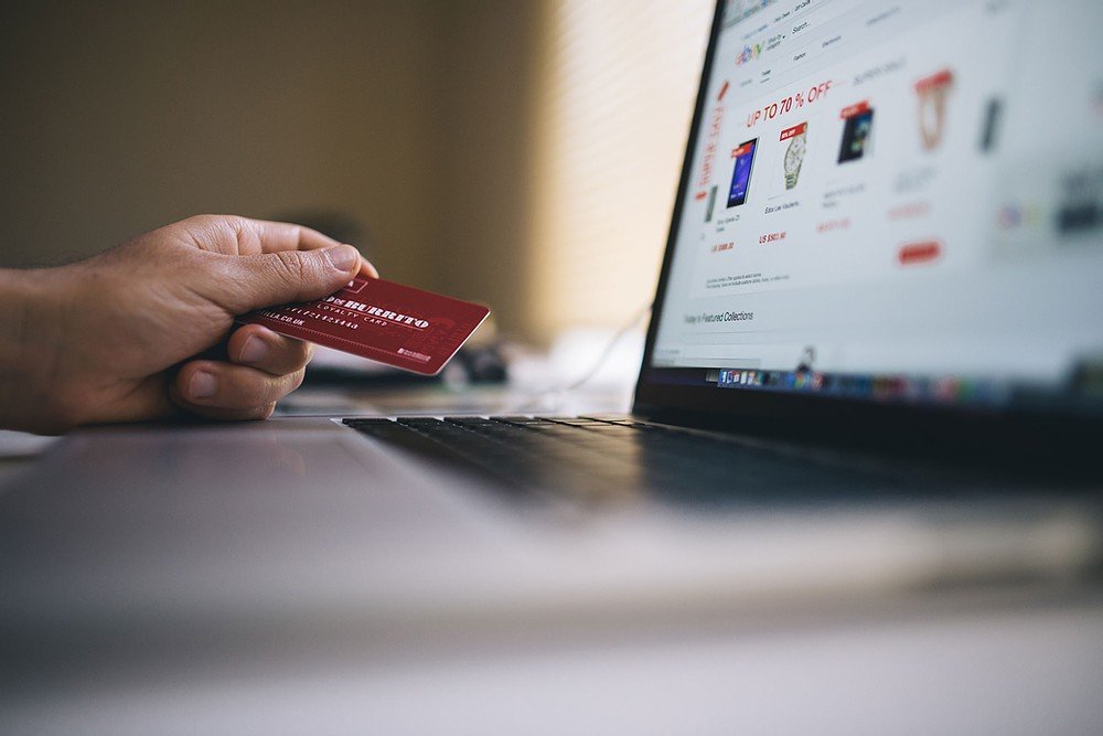 Man holding credit card doing online shopping