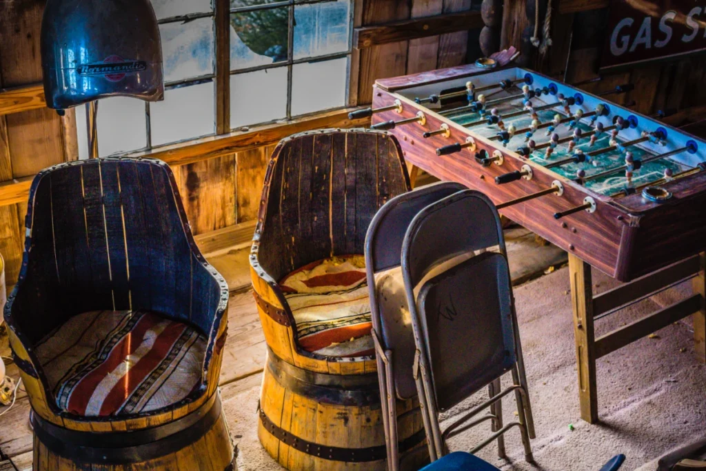 man cave showing some comfortable chairs and a foosball table