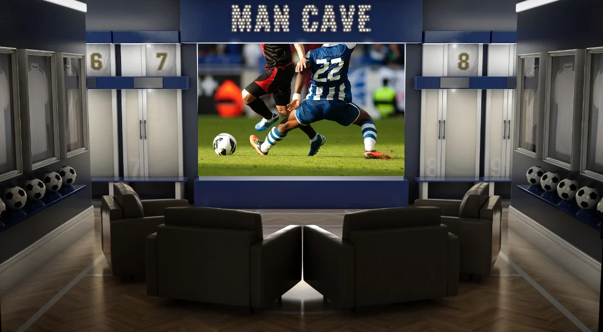 a photo of a man cave with a soccer game on a projection television.