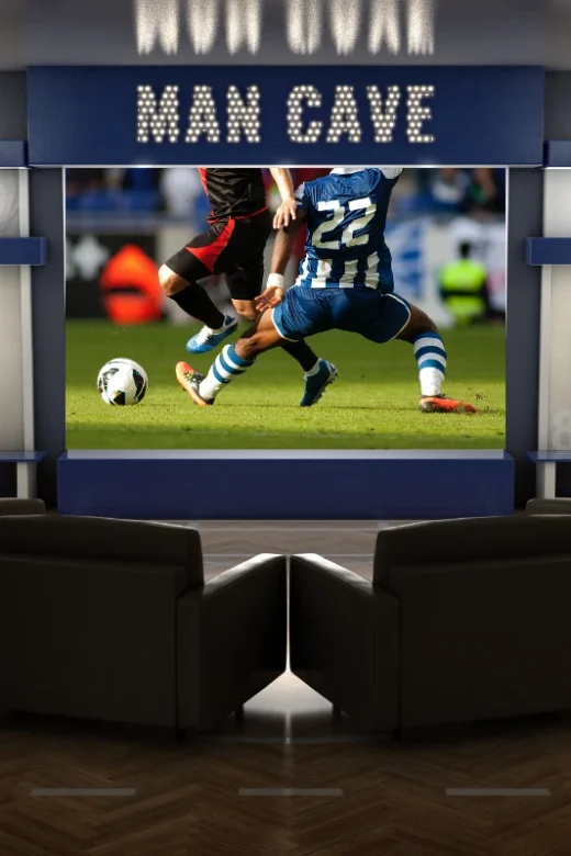 a photo of a man cave with a soccer game on a projection television.